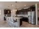 Gourmet kitchen with stainless steel appliances, a large island, and ample cabinet space at 40707 W Pryor Ln, Maricopa, AZ 85138
