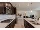 Stylish kitchen with stainless appliances, gas cooktop, white subway tile backsplash, and an island with a sink at 40707 W Pryor Ln, Maricopa, AZ 85138