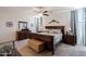 Spacious main bedroom with dark furniture and carpeted floors at 40707 W Pryor Ln, Maricopa, AZ 85138