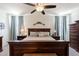Cozy main bedroom featuring a bed with wooden frame at 40707 W Pryor Ln, Maricopa, AZ 85138