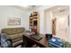 Well-lit office space with a ceiling fan and a comfortable sofa at 40707 W Pryor Ln, Maricopa, AZ 85138