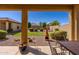Covered patio with a charming view of the well-manicured backyard at 40707 W Pryor Ln, Maricopa, AZ 85138