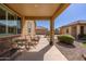 Relaxing covered patio with comfortable seating, offering a serene outdoor retreat at 40707 W Pryor Ln, Maricopa, AZ 85138
