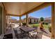 Inviting covered patio with outdoor dining set, perfect for entertaining at 40707 W Pryor Ln, Maricopa, AZ 85138