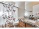 Bright bathroom featuring granite countertops and a floral shower curtain at 4539 W Beautiful Ln, Laveen, AZ 85339