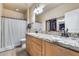 Bathroom with double sinks, granite counters, a shower/tub combination and a closet at 4539 W Beautiful Ln, Laveen, AZ 85339