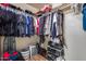 Walk in closet featuring organized hanging clothes, shelves, and shoe racks at 4539 W Beautiful Ln, Laveen, AZ 85339
