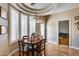 Bright dining area featuring a wood table, modern light fixture, and large windows at 4539 W Beautiful Ln, Laveen, AZ 85339