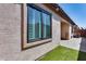 Exterior view of stucco home with window and small patch of turf at 4539 W Beautiful Ln, Laveen, AZ 85339