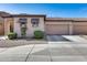 Charming home exterior featuring a two-car garage and low-maintenance landscaping at 4539 W Beautiful Ln, Laveen, AZ 85339