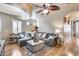 Comfortable living room with a sectional sofa, a ceiling fan, and bright natural light at 4539 W Beautiful Ln, Laveen, AZ 85339