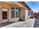 Paved patio with views of exterior stucco home, green turf, and desert landscaping at 4539 W Beautiful Ln, Laveen, AZ 85339