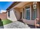 Inviting outdoor patio with paved brick, stucco walls, and green turf at 4539 W Beautiful Ln, Laveen, AZ 85339