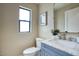 Stylish half bathroom featuring a blue vanity with marble countertop and modern fixtures at 4602 N 74Th Pl, Scottsdale, AZ 85251