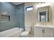 Well-lit bathroom with a bathtub, tiled walls, modern fixtures, and a sink with a vanity at 4602 N 74Th Pl, Scottsdale, AZ 85251