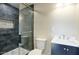 Bathroom featuring tiled walk-in shower with dark accent and vanity with modern fixtures at 4602 N 74Th Pl, Scottsdale, AZ 85251