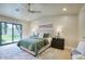 Cozy bedroom with a sliding glass door to the backyard, soft lighting, and neutral color scheme at 4602 N 74Th Pl, Scottsdale, AZ 85251