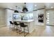 Beautiful kitchen featuring white cabinetry, stainless steel appliances, and a spacious island with bar stools at 4602 N 74Th Pl, Scottsdale, AZ 85251