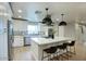 Modern kitchen with stainless steel appliances, a large island with seating, and sleek white cabinets at 4602 N 74Th Pl, Scottsdale, AZ 85251