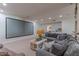 Home theater area with large screen, plush seating, and integrated sound system in basement at 4617 E Elmwood Cir, Mesa, AZ 85205