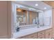 Close-up view of the bathroom vanity featuring white countertops and a large mirror at 4617 E Elmwood Cir, Mesa, AZ 85205