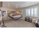 Bright bedroom showcasing unique floating bed design and ample natural light through shutters at 4617 E Elmwood Cir, Mesa, AZ 85205