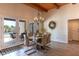 A stylish dining area has glass doors, chandelier lighting, and views of the backyard swimming pool at 4617 E Elmwood Cir, Mesa, AZ 85205
