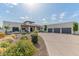 Expansive single-story home with a four-car garage and beautiful desert landscaping at 4617 E Elmwood Cir, Mesa, AZ 85205