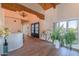 Inviting foyer with tile flooring, chandelier, exposed beams, and natural light at 4617 E Elmwood Cir, Mesa, AZ 85205