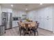 Charming kitchen with stainless steel appliances, a circular wooden table and ample cabinet space at 4617 E Elmwood Cir, Mesa, AZ 85205
