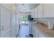 Well-organized laundry room with lots of cabinetry, modern appliances, and backyard access at 4617 E Elmwood Cir, Mesa, AZ 85205