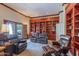 A living area with carpeted floors, custom built-in shelving, and comfortable reclining chairs at 4617 E Elmwood Cir, Mesa, AZ 85205