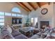Spacious living room with vaulted ceiling, exposed beams, fireplace, and lots of natural light at 4617 E Elmwood Cir, Mesa, AZ 85205