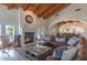Open concept living room with fireplace, wood beams, and access to outdoor pool area at 4617 E Elmwood Cir, Mesa, AZ 85205