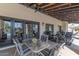 Inviting covered patio with stylish furniture, ceiling fans and string lights, perfect for outdoor entertaining at 4617 E Elmwood Cir, Mesa, AZ 85205