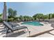 Backyard pool with lounge chairs, mature landscaping and lush, tropical palm trees for a relaxing retreat at 4617 E Elmwood Cir, Mesa, AZ 85205