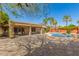 Expansive backyard featuring a pool, covered patio, paver stones, and lush tropical landscaping at 4901 S Vista Pl, Chandler, AZ 85248