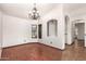 Bright dining room with wood floors, chandelier, and views of the front yard through a large window at 4901 S Vista Pl, Chandler, AZ 85248