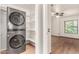 This laundry space features modern gray washer and dryer machines with lots of storage space adjacent to them at 4901 S Vista Pl, Chandler, AZ 85248