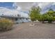 Large backyard with desert landscaping, mature trees, and ample space for outdoor activities at 5317 E Baltimore St, Mesa, AZ 85205
