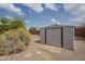 Backyard shows storage shed and partial brick border at 5317 E Baltimore St, Mesa, AZ 85205