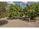 Backyard featuring mature fruit trees and stone bench at 5317 E Baltimore St, Mesa, AZ 85205