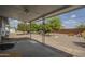 Covered patio overlooking backyard, gravel, trees, and partial brick border at 5317 E Baltimore St, Mesa, AZ 85205