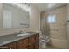 Bathroom with a classic vanity, tiled shower, and tub combo at 5317 E Baltimore St, Mesa, AZ 85205