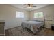 Cozy bedroom with neutral walls, two windows, and a ceiling fan at 5317 E Baltimore St, Mesa, AZ 85205