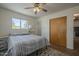 Calm bedroom features a neutral palette, wood laminate flooring, and closet at 5317 E Baltimore St, Mesa, AZ 85205