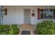Covered front porch with desert shrubbery, red shutters, and a security door at 5317 E Baltimore St, Mesa, AZ 85205