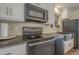 Modern kitchen with stainless steel appliances and granite countertops at 5317 E Baltimore St, Mesa, AZ 85205
