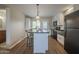 Well-appointed kitchen featuring an island with seating, black appliances, and laminate floors at 5317 E Baltimore St, Mesa, AZ 85205