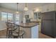 Bright kitchen featuring an island with bar seating, white cabinets, and modern appliances at 5317 E Baltimore St, Mesa, AZ 85205
